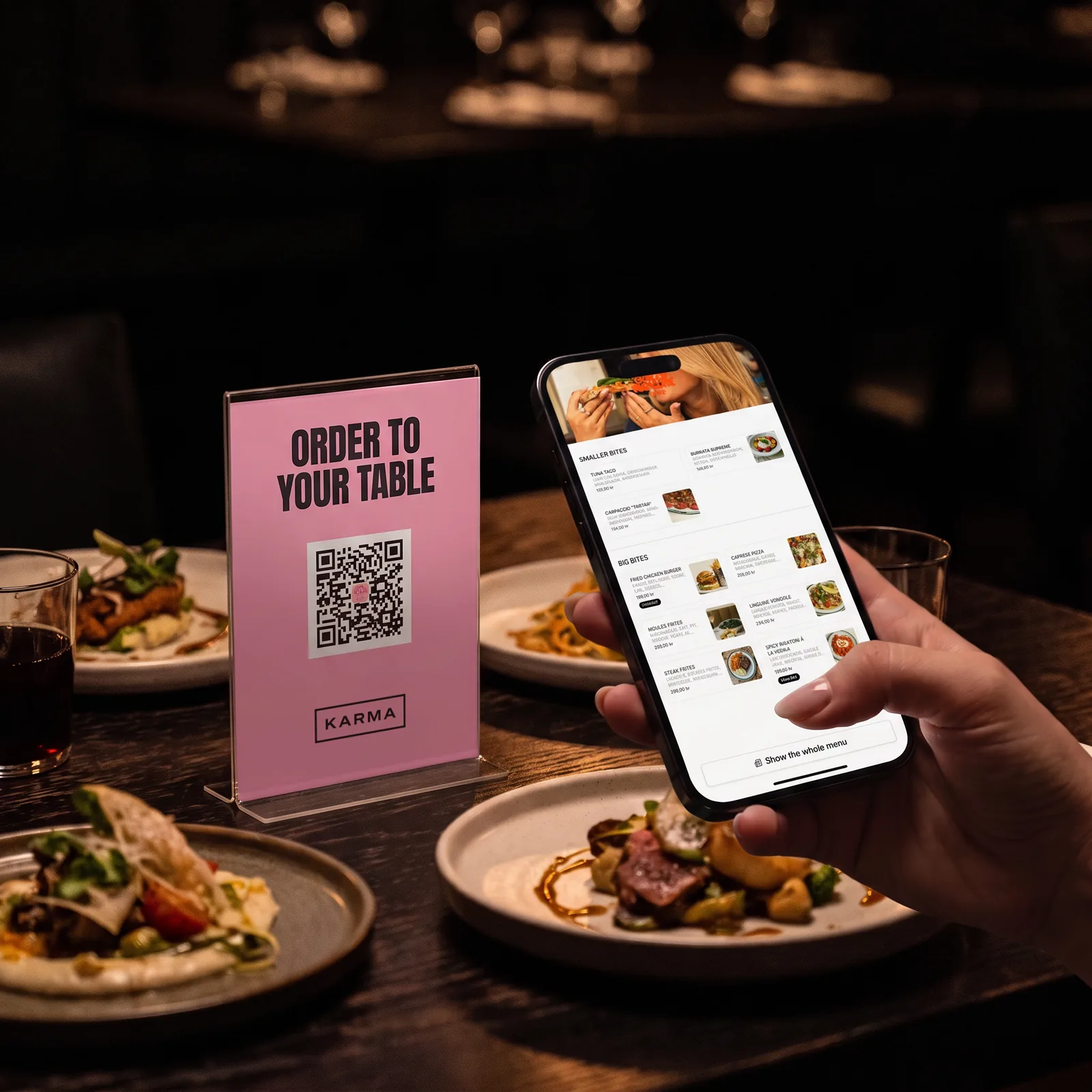 Karma's QR sign on a restaurant table and the menu on the guest's phone